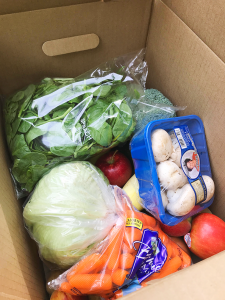 Box of fruits and vegetables for donation.